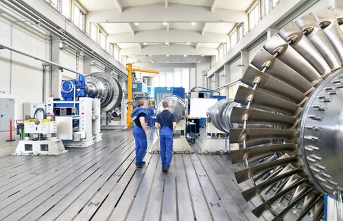 Workers in a turbine manufacturing facility, representing energy sector careers