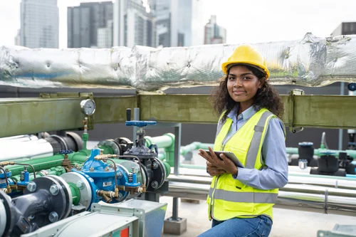 Maintenance worker in an industrial facility, representing skilled trades careers in utilities and construction